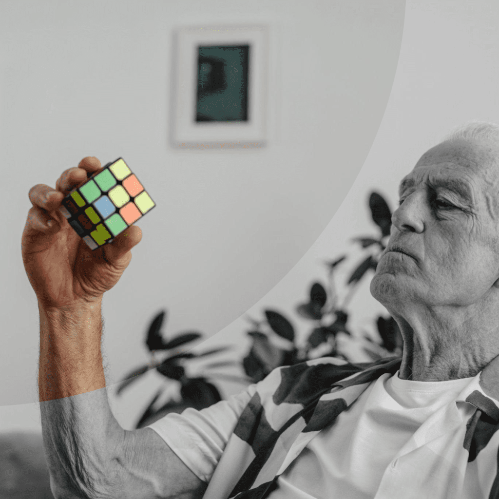 An old man solving a Rubiks cube.