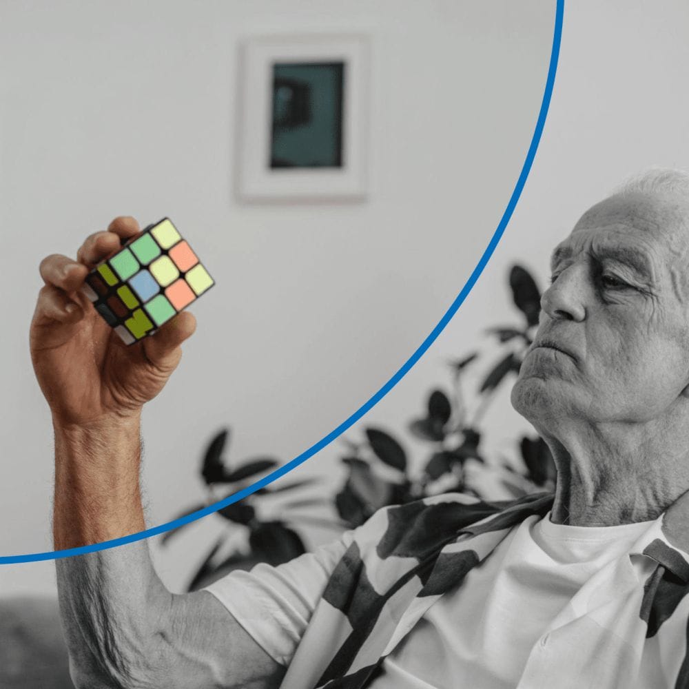 An old man solving a Rubiks cube.