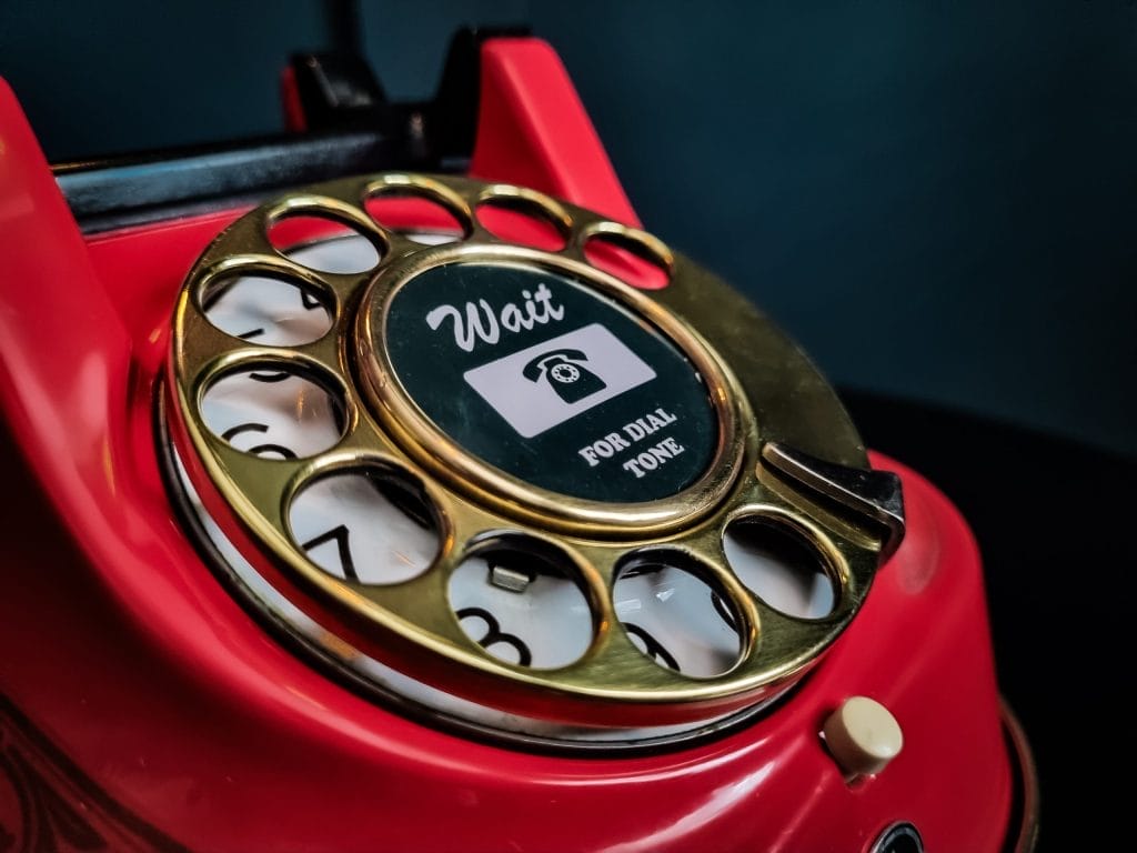 Close up of an antique red telephone.